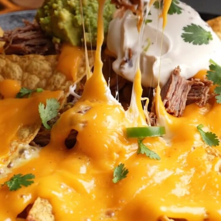 Loaded skillet nachos with smoked brisket, molten queso, and toppings