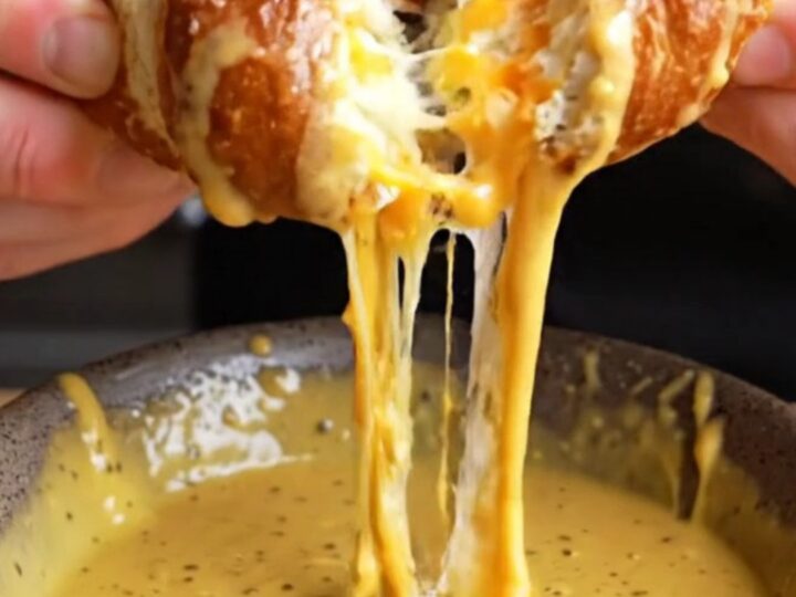 Golden brown pretzels stuffed with cheese, with a honey mustard dip on the side