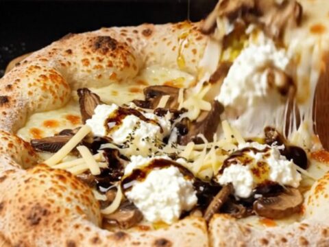 Blistered sourdough pizza with melted fontina, mushrooms, and truffle oil drizzle