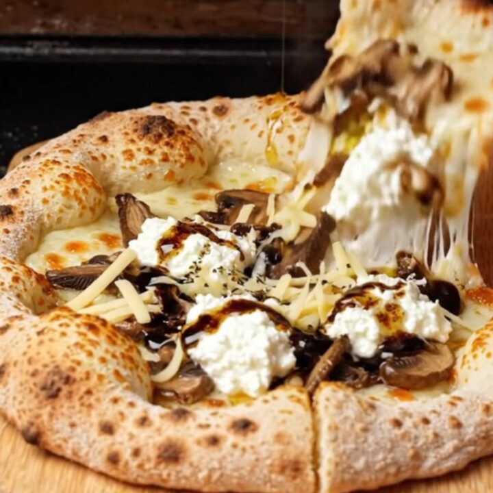 Blistered sourdough pizza with melted fontina, mushrooms, and truffle oil drizzle