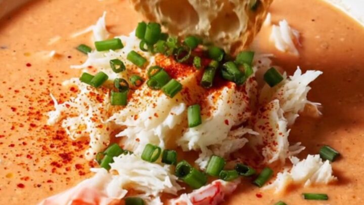 Creamy crab bisque in a bowl topped with jumbo lump crab and chives