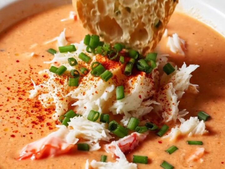 Creamy crab bisque in a bowl topped with jumbo lump crab and chives