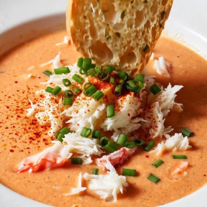Creamy crab bisque in a bowl topped with jumbo lump crab and chives