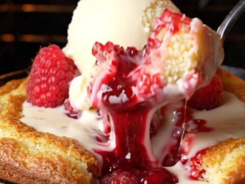 Molten white chocolate raspberry skillet lava cake with vanilla ice cream