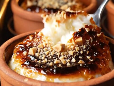 Caramelized top of Turkish rice pudding with cracks and hazelnuts
