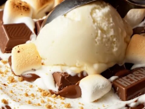Giant s'mores skillet pizookie with toasted marshmallow fluff and chocolate, served with ice cream