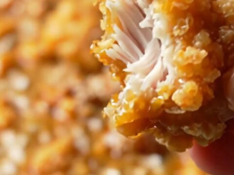 Crispy Korean honey butter popcorn chicken in a bowl, glazed and sprinkled with sesame seeds
