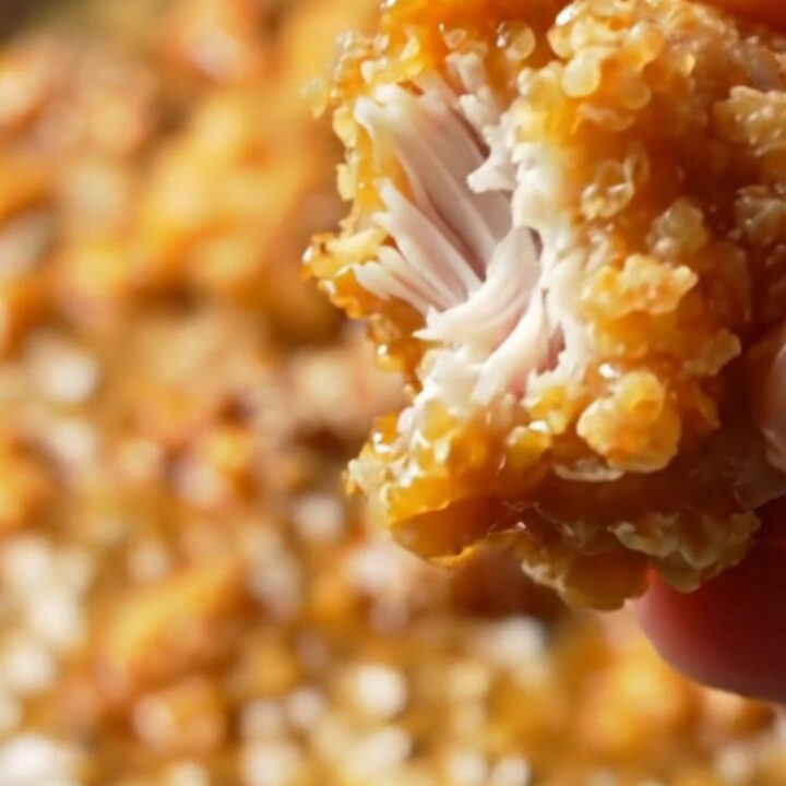Crispy Korean honey butter popcorn chicken in a bowl, glazed and sprinkled with sesame seeds