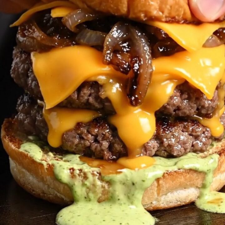 Double Wagyu smash burger with melted cheddar, caramelized onions, and wasabi aioli on a toasted brioche bun