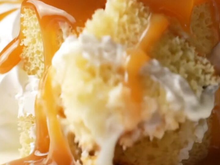 A square of Turkish Trileçe with amber caramel and whipped cream, fork lifting a bite