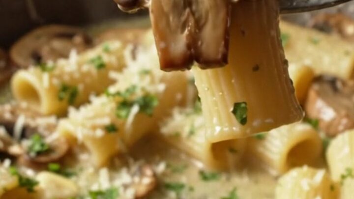 Creamy Boursin mushroom pasta in a skillet, with rigatoni coated in a herb-speckled sauce and golden mushrooms.
