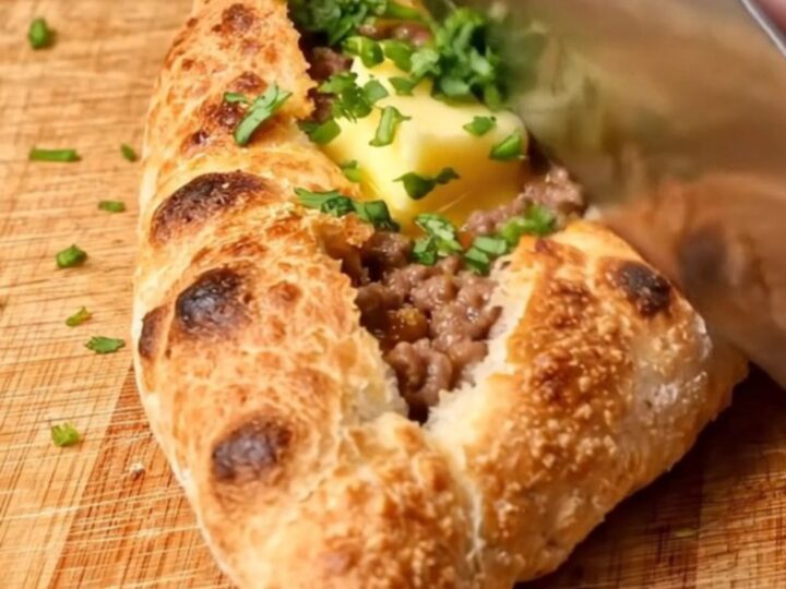 Golden folded Turkish pide with blistered crust and melted butter