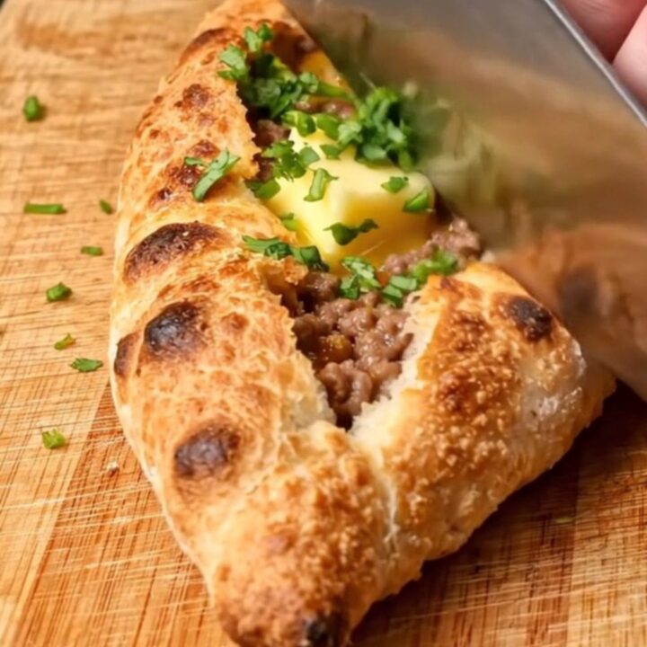 Golden folded Turkish pide with blistered crust and melted butter