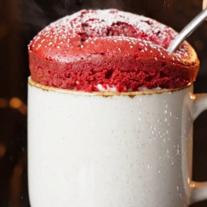 Red velvet mug cake with molten cream cheese center flowing out