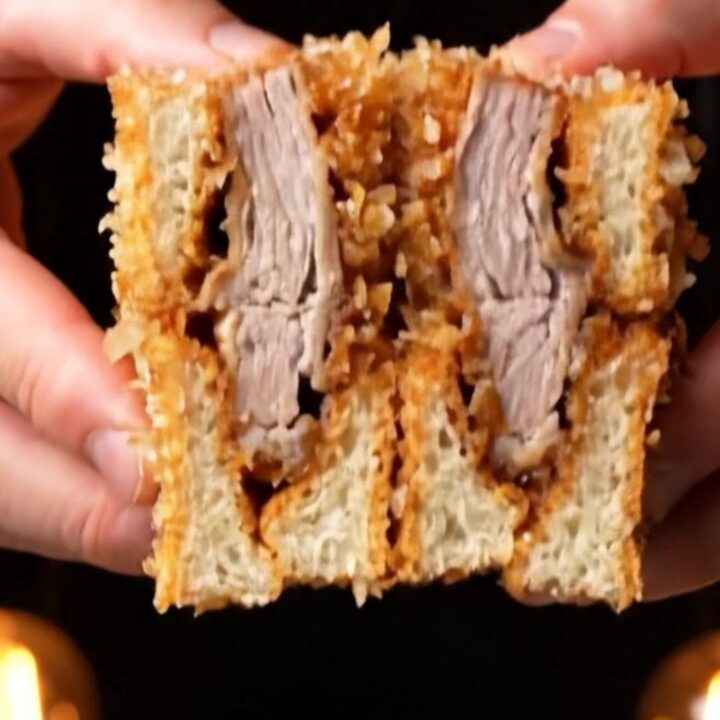 Japanese pork katsu sando sliced in half showing golden panko crust, juicy pork, and cabbage on milk bread
