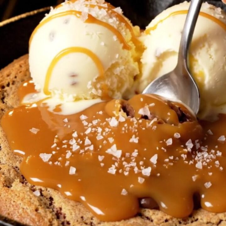 Warm skillet pizookie with vanilla gelato and caramel drizzle