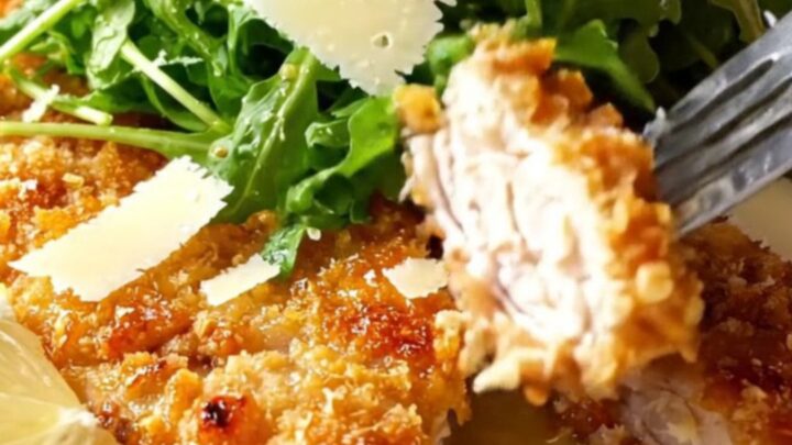 Golden crispy chicken cutlets topped with lemon arugula salad and shaved parmesan