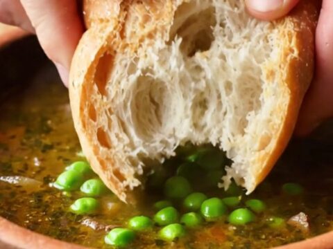 A bowl of Turkish forest lamb stew with tender meat, peas, carrots, and potatoes in rich broth