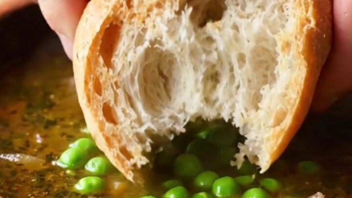 A bowl of Turkish forest lamb stew with tender meat, peas, carrots, and potatoes in rich broth