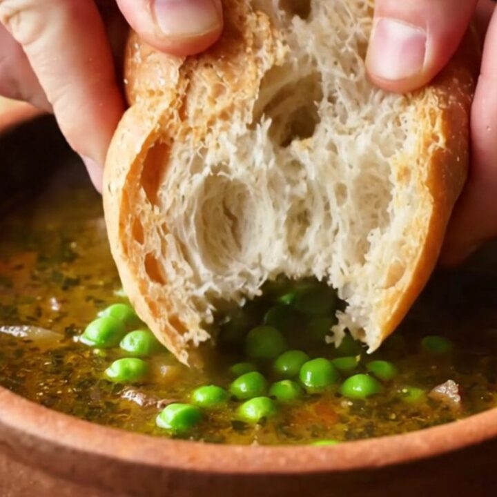 A bowl of Turkish forest lamb stew with tender meat, peas, carrots, and potatoes in rich broth