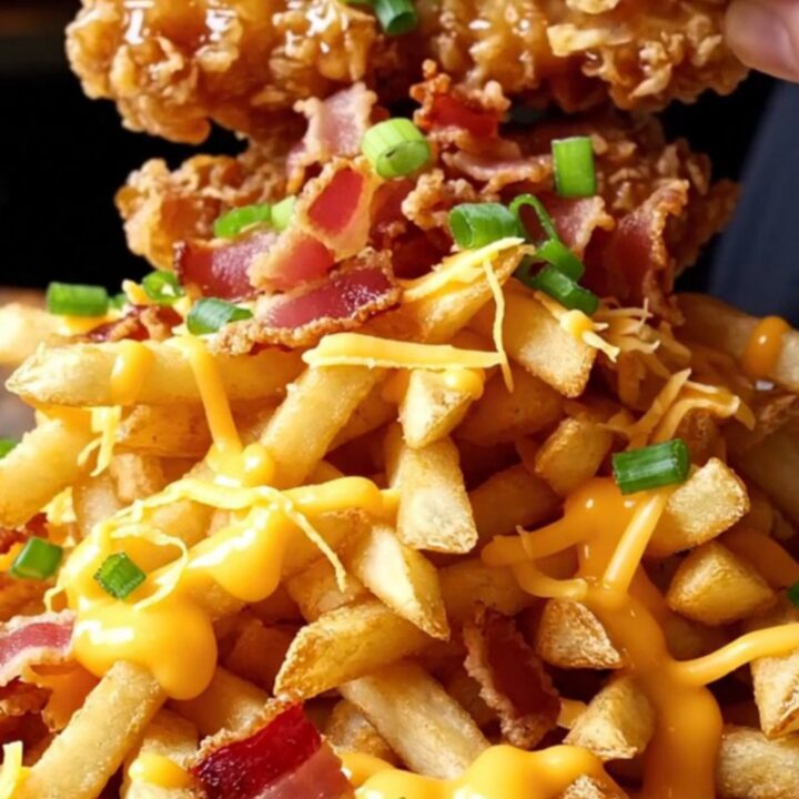 Crispy honey garlic chicken tenders on loaded bacon fries with melted cheddar and green onions.
