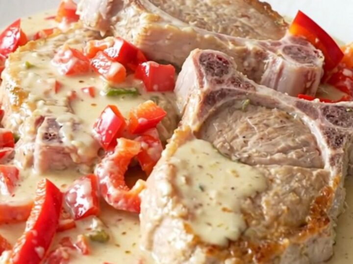 Slow cooker creamy pepper jack pork chops with red peppers in a creamy sauce