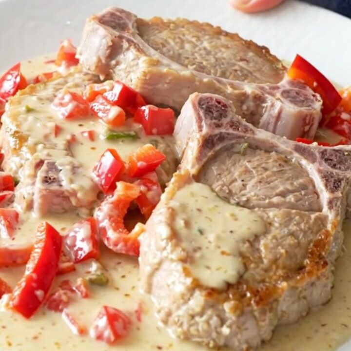 Slow cooker creamy pepper jack pork chops with red peppers in a creamy sauce