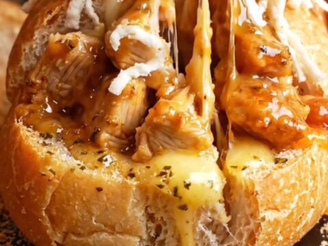 Golden baguette stuffed with hot honey garlic chicken and melted mozzarella, sliced thick with cheese pull