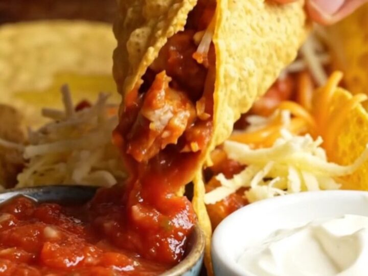 Golden baked chicken tacos with melted cheese on a sheet pan, ready to serve