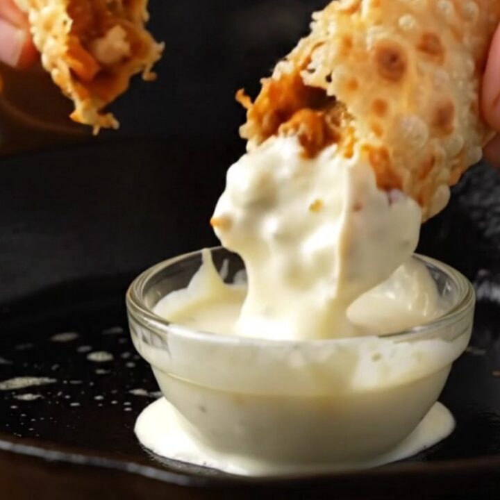 Crispy chicken lavash wrap cut in half showing melted cheese and chicken