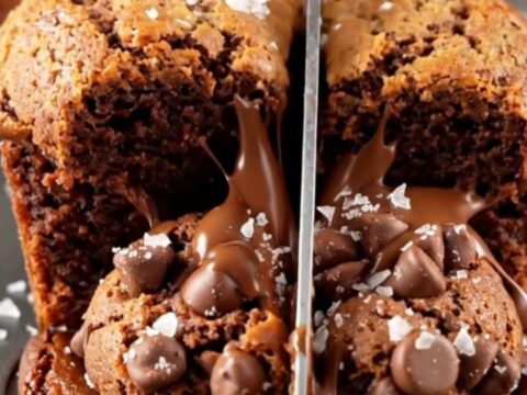 Brown butter brookie cups broken open showing fudgy brownie and cookie layers with melted chocolate.
