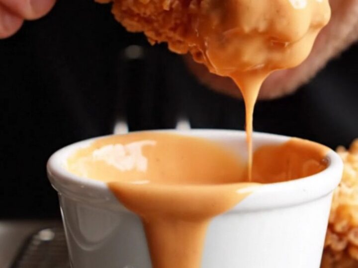Crispy golden chicken fingers with a side of Cane's sauce