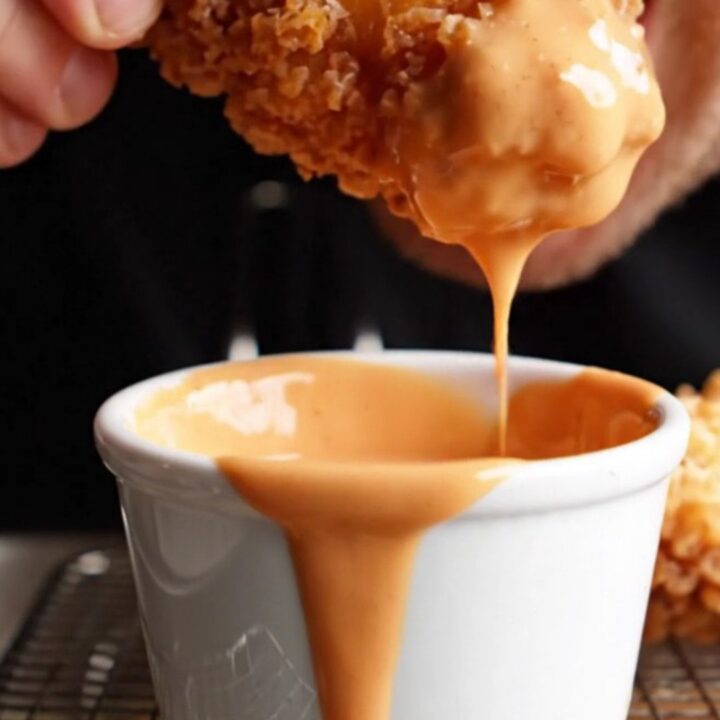 Crispy golden chicken fingers with a side of Cane's sauce