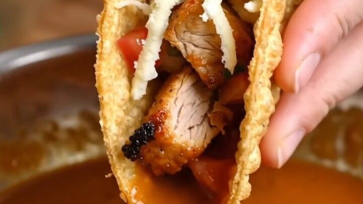 Golden crispy chicken tacos topped with fresh pico de gallo and spicy cream sauce