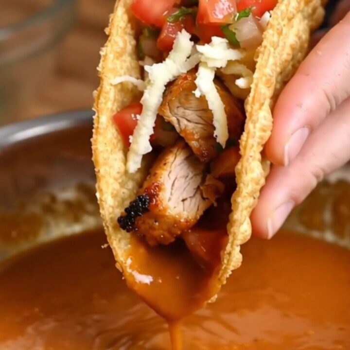 Golden crispy chicken tacos topped with fresh pico de gallo and spicy cream sauce