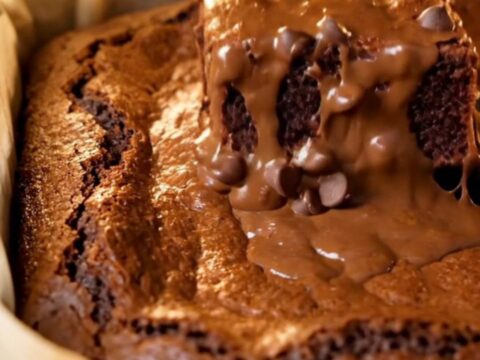 A stack of brown butter fudgy brownies with shiny crinkled tops and gooey centers