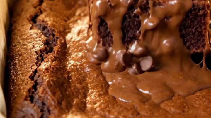 A stack of brown butter fudgy brownies with shiny crinkled tops and gooey centers