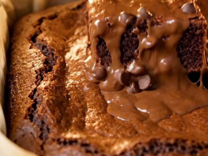 A stack of brown butter fudgy brownies with shiny crinkled tops and gooey centers