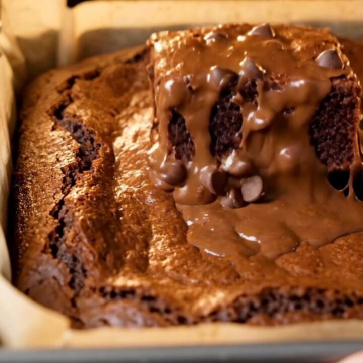 A stack of brown butter fudgy brownies with shiny crinkled tops and gooey centers