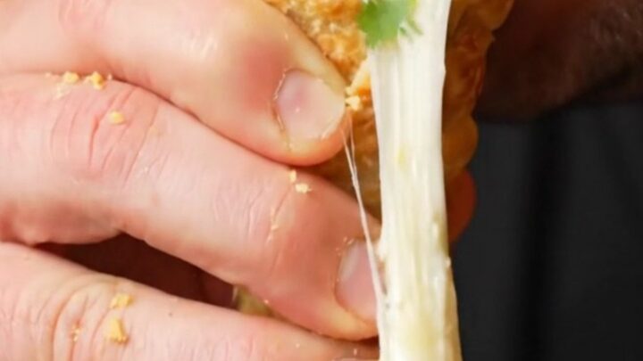 Crispy golden tortilla cone filled with seasoned beef and melted mozzarella, cheese pulling as it's lifted