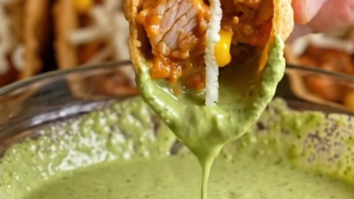 Golden crispy oven-baked chicken tacos with creamy filling, served with cilantro lime crema