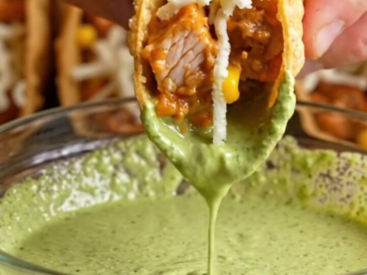 Golden crispy oven-baked chicken tacos with creamy filling, served with cilantro lime crema
