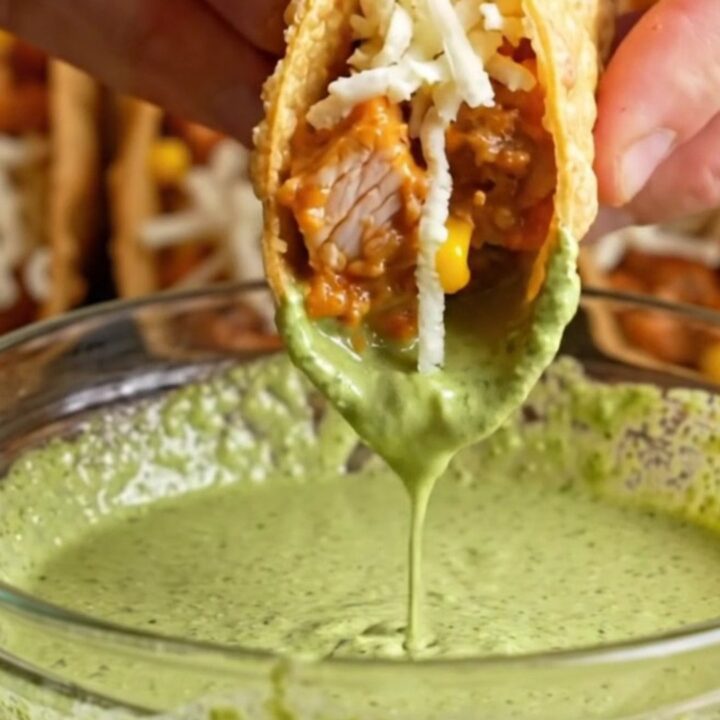 Golden crispy oven-baked chicken tacos with creamy filling, served with cilantro lime crema