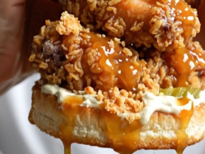 A towering fried chicken sandwich with honey chipotle glaze dripping over the crispy crust