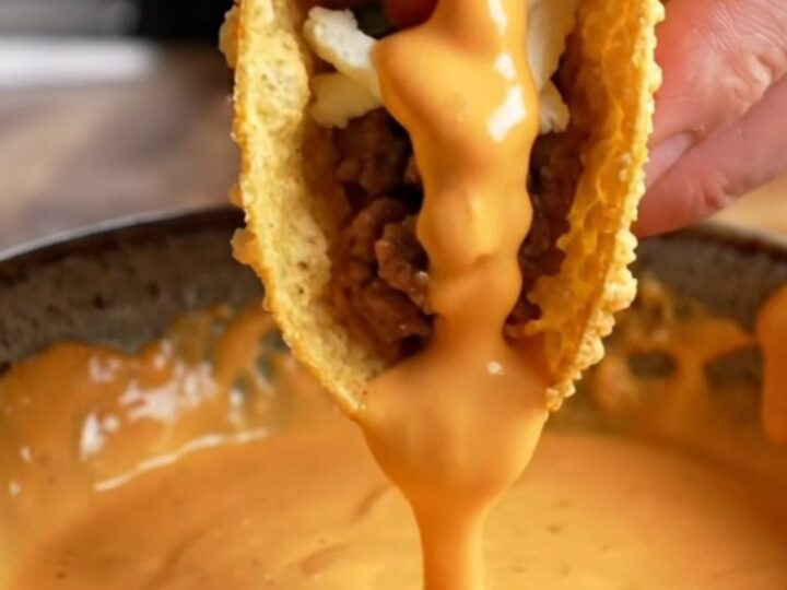 Crispy pan-fried beef taco topped with pico de gallo and creamy sauce