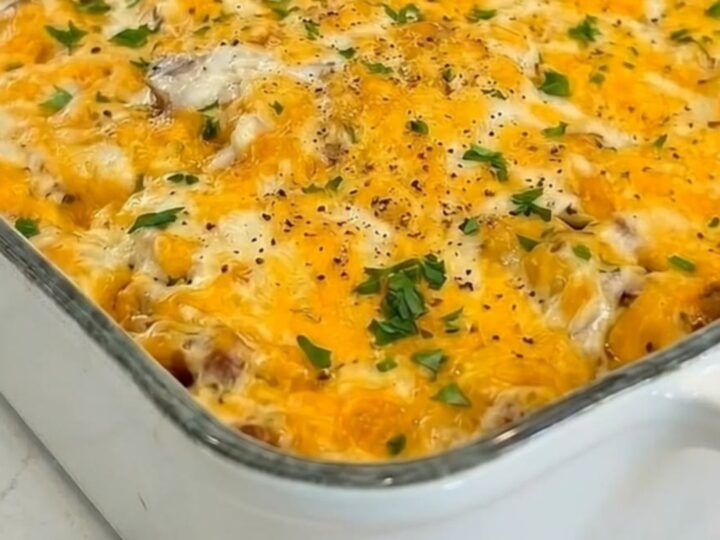 A hearty portion of hobo casserole being lifted with a spatula, showing an epic melted cheese pull.
