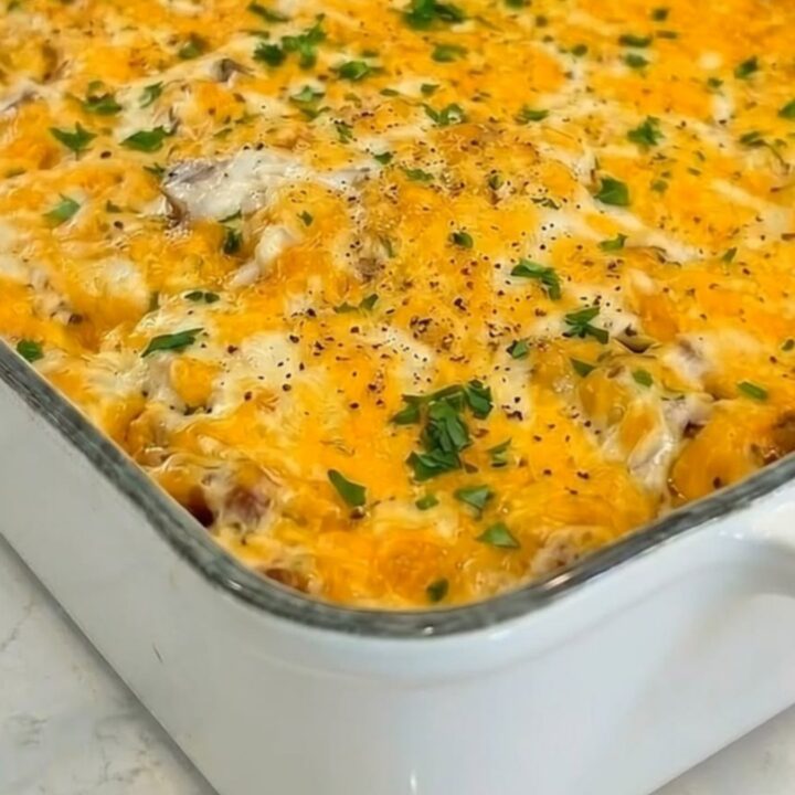 A hearty portion of hobo casserole being lifted with a spatula, showing an epic melted cheese pull.