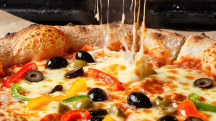 Golden bakery-style pizza with blistered crust and stretchy mozzarella