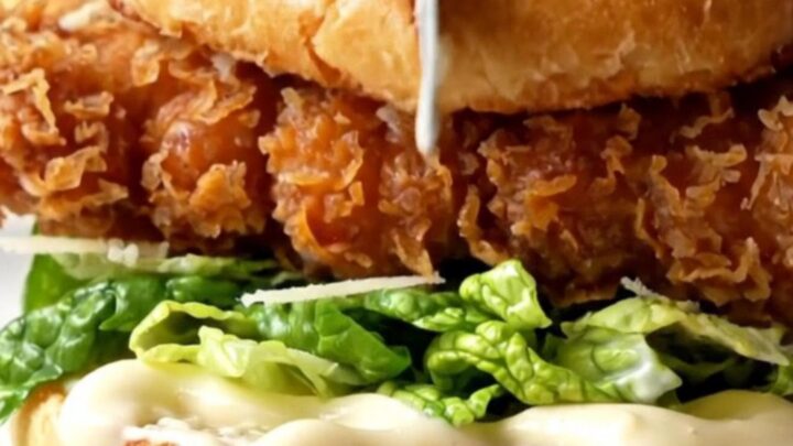 Crispy chicken Caesar sandwich with golden fried chicken, romaine, and shaved parmesan on a toasted brioche bun