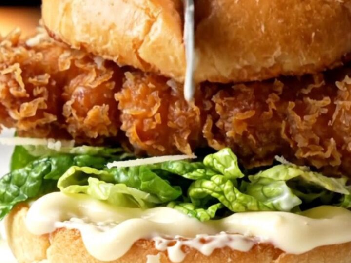 Crispy chicken Caesar sandwich with golden fried chicken, romaine, and shaved parmesan on a toasted brioche bun
